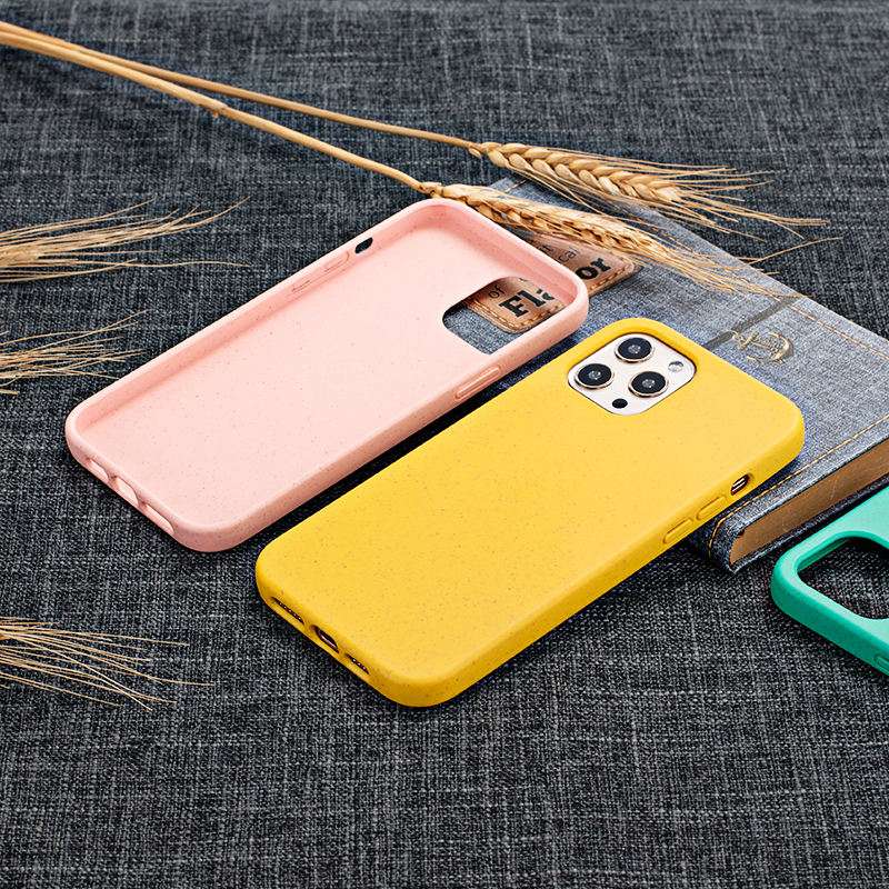 Back view of pink and yellow Eco-Friendly Slimline iPhone Cases on fabric surface, highlighting minimalist design and eco-conscious materials.
