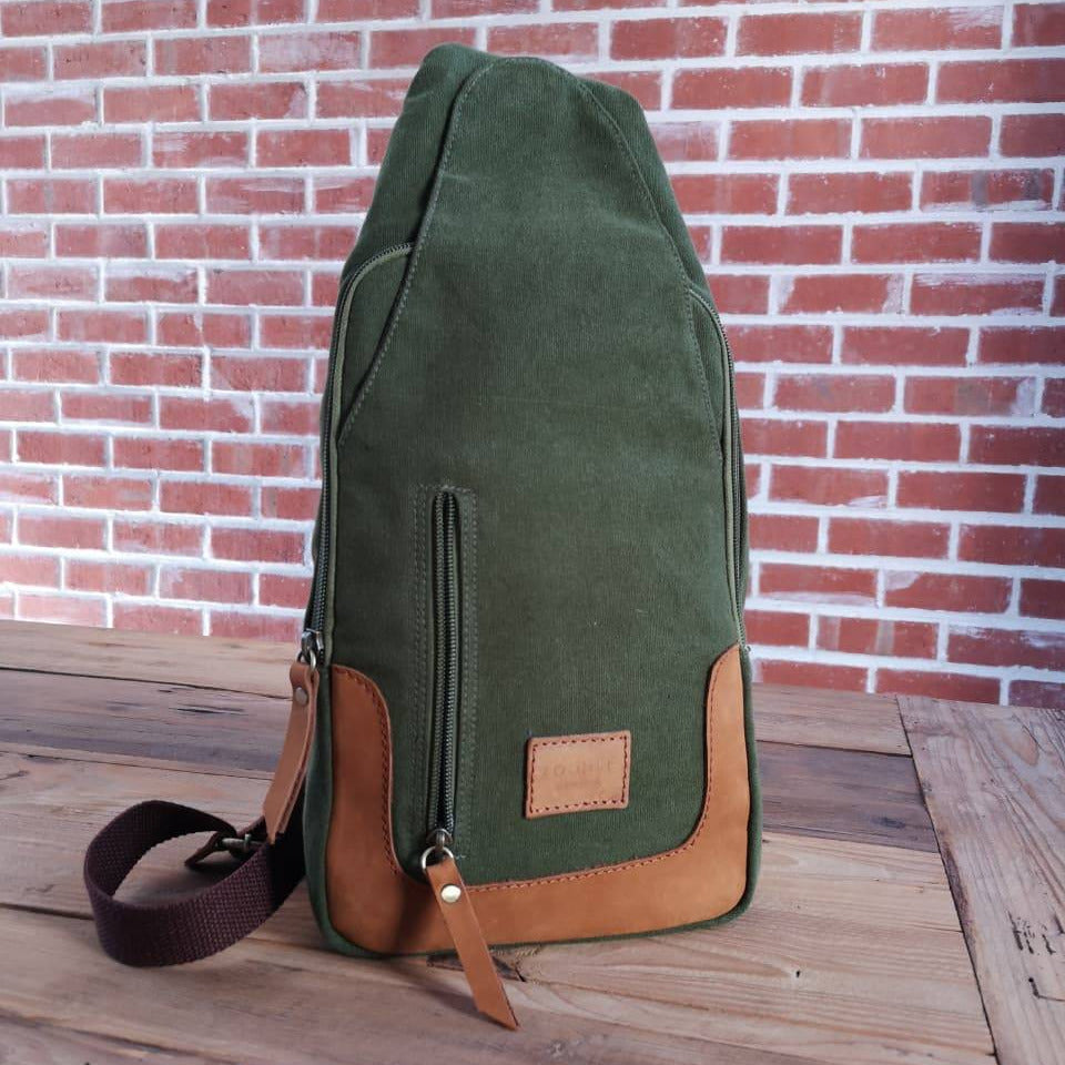 Front view of Zoodle Olive iPad Sling Bag with leather zipper pulls and patch, combining function and fashion for South African users.