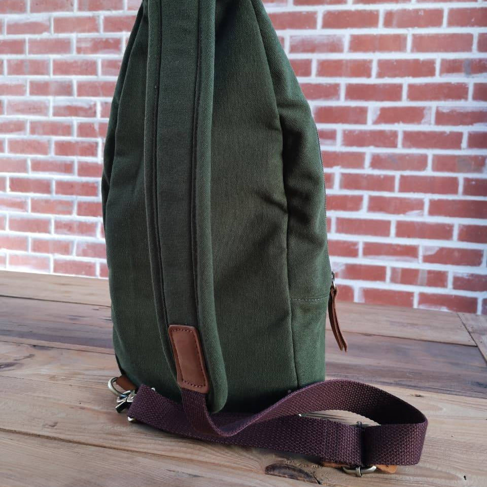 Side profile of Zoodle Olive iPad Sling Bag showing durable canvas and brown strap, designed for comfort and mobility in South Africa.