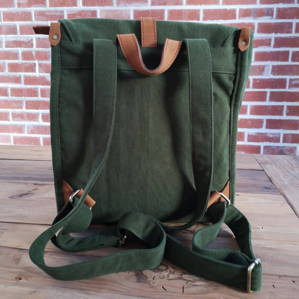Back view of Zoodle Laptop Backpack in green canvas with adjustable straps and leather accents, designed for comfort and style.