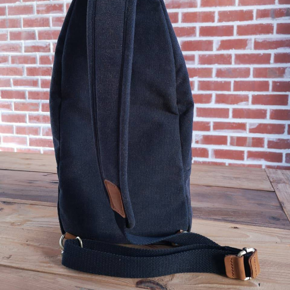 Side view of Zoodle charcoal canvas iPad Sling Bag with adjustable strap and leather detailing, perfect for daily use in South Africa.