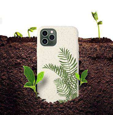 White Eco-Friendly Slimline iPhone Case with green fern design planted in soil, symbolizing its biodegradable and compostable nature.