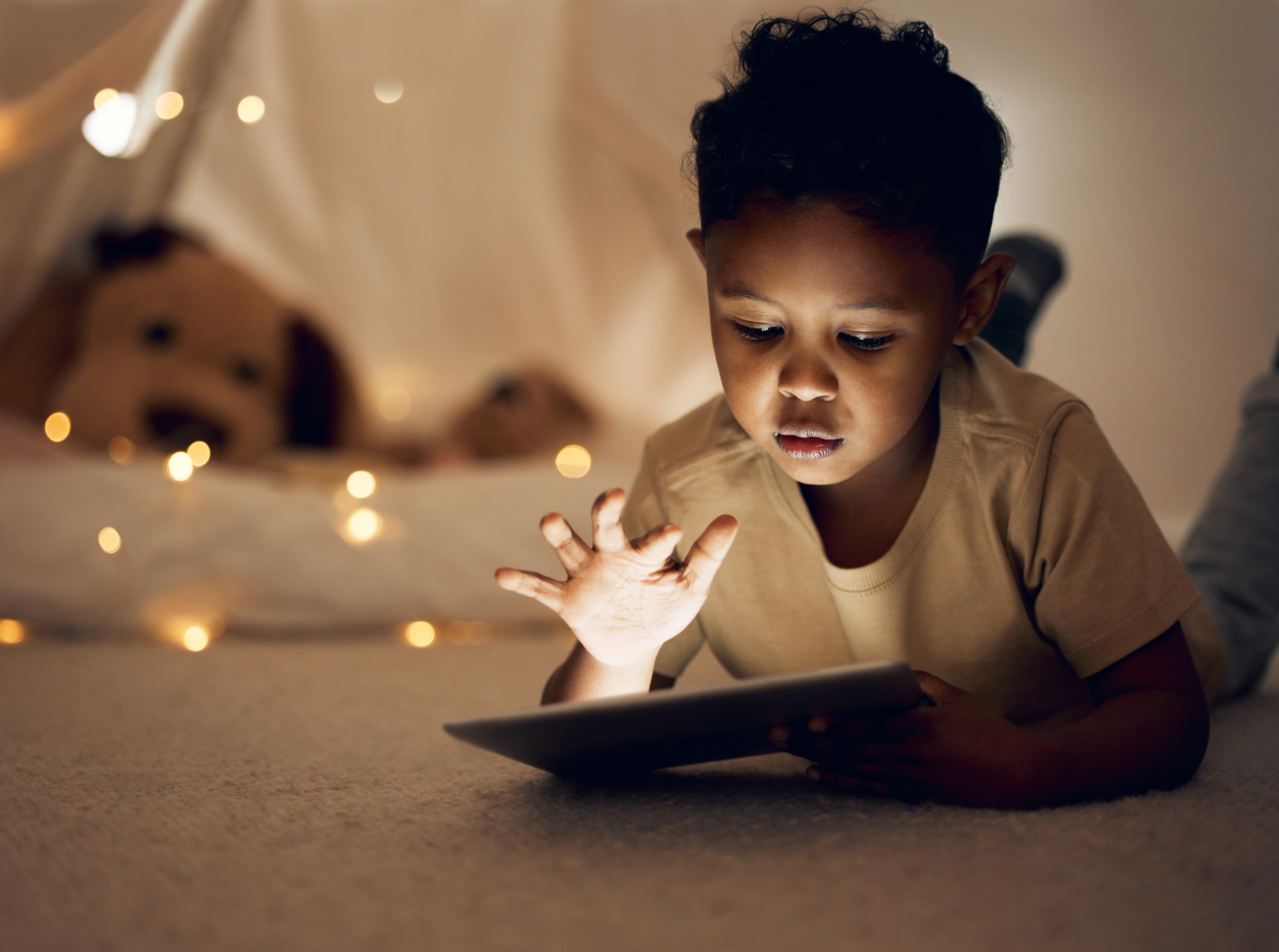 Child playing on aiPad with a flip case in a cozy light spot