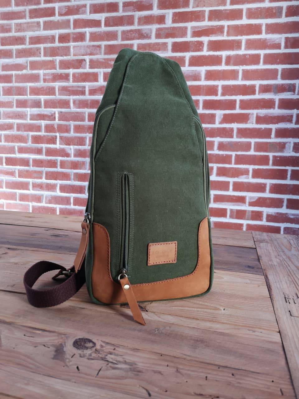 Front view of Zoodle Olive iPad Sling Bag with leather zipper pulls and patch, combining function and fashion for South African users.