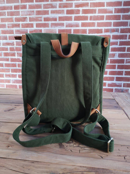 Back view of Zoodle Laptop Backpack in green canvas with adjustable straps and leather accents, designed for comfort and style.