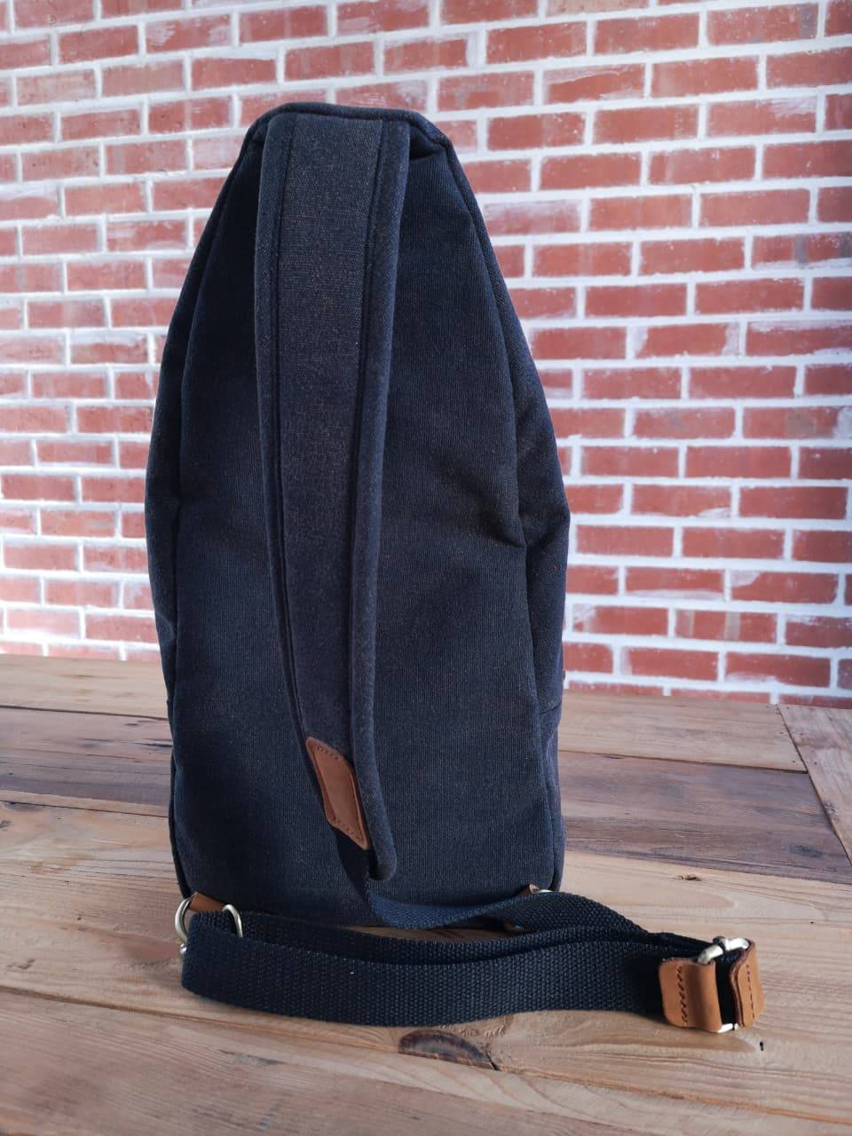 Side view of Zoodle charcoal canvas iPad Sling Bag with adjustable strap and leather detailing, perfect for daily use in South Africa.