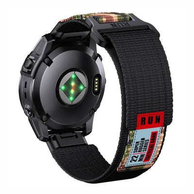 Rear view of Tactical QuickFit Strap for GARMIN in camo and black. Rugged nylon with Velcro fastening and red label for 22mm Garmin watches.